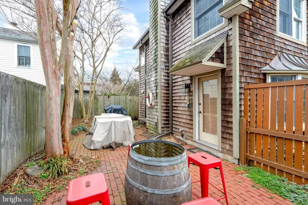 a backyard of a house with outdoor seating