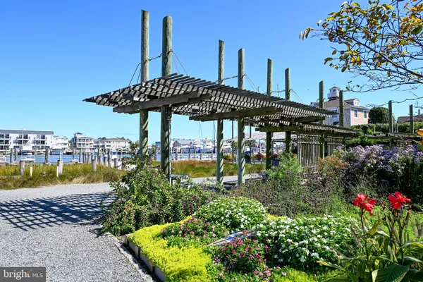 a view of water with boats and trees in the background