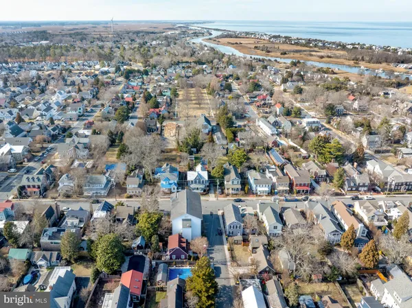 a view of a house with a wooden fence