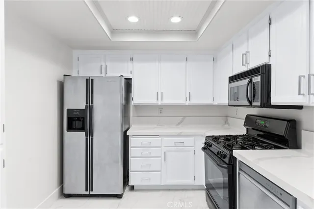 a kitchen with a refrigerator stove and microwave