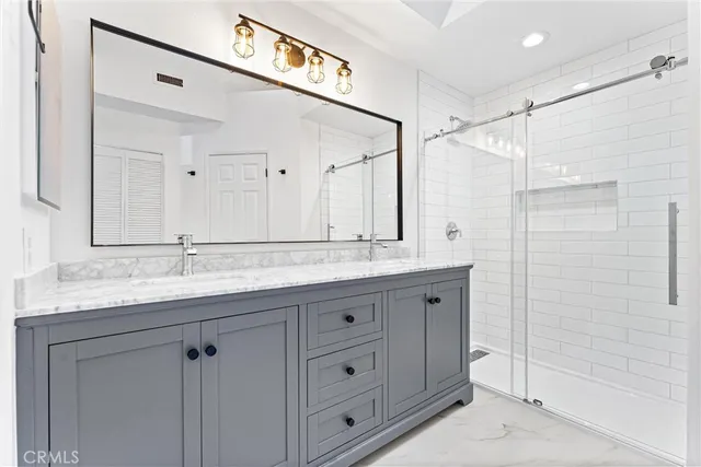 a bathroom with a granite countertop sink mirror and double