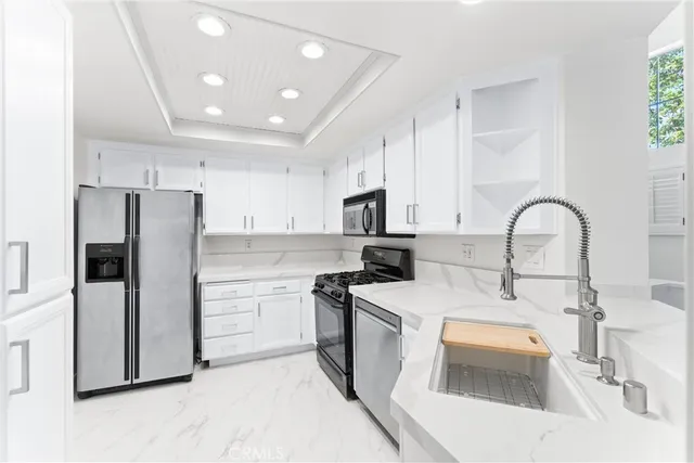 a kitchen with a sink a stove a refrigerator and a refrigerator