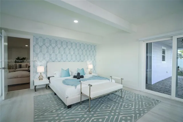 a view of a patio with table and chairs potted plants with wooden floor and fence