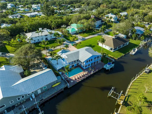 an aerial view of a house with a lake view