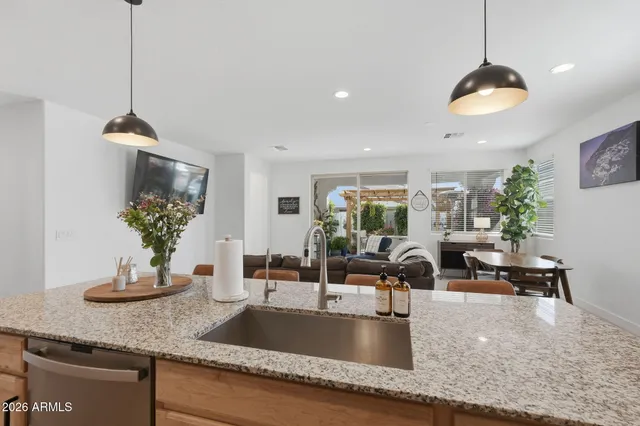 a kitchen with stainless steel appliances granite countertop a sink a counter space and a counter top space