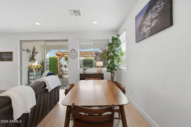 a view of a dining room with furniture and a potted plant