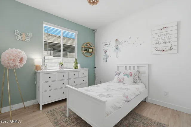 a bedroom with a bed and a dresser