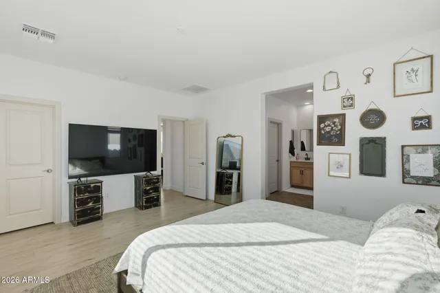 a bedroom with a bed and a flat screen tv