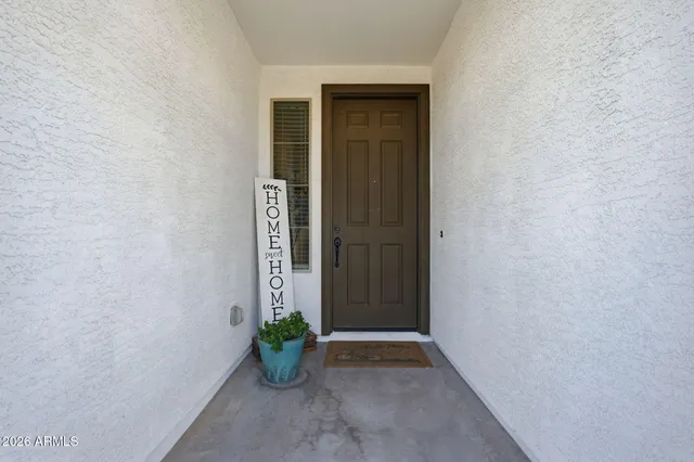 an empty room with potted plants in front of door