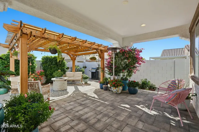 a view of a patio with table and chairs potted plants