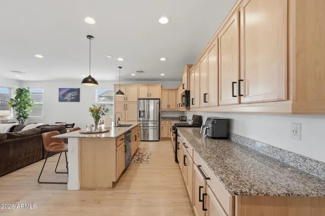 a kitchen with stainless steel appliances granite countertop sink stove and cabinets