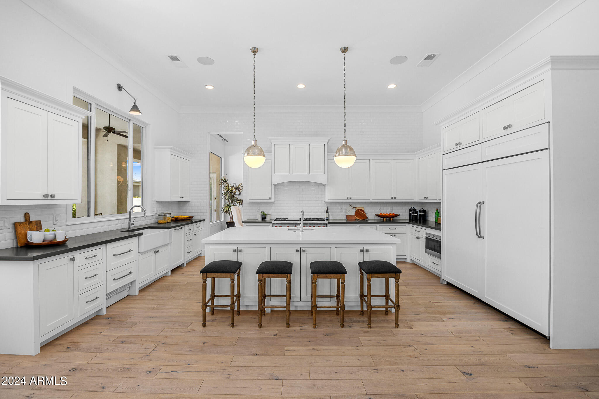 2654 East Warbler Road Gilbert, AZ 85297 - Photo 11 of 50 a large kitchen with a table and chairs