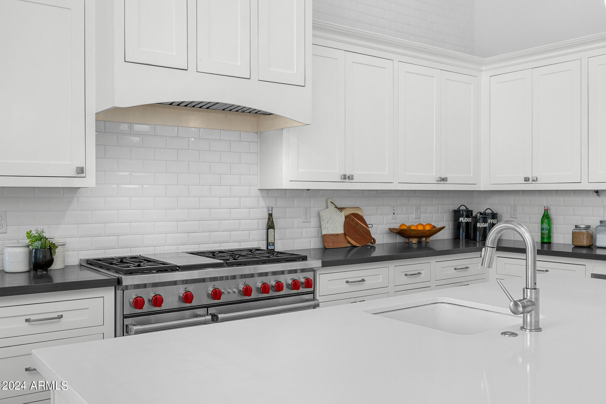 2654 East Warbler Road Gilbert, AZ 85297 - Photo 13 of 50 a kitchen with stainless steel appliances a sink a stove and cabinets