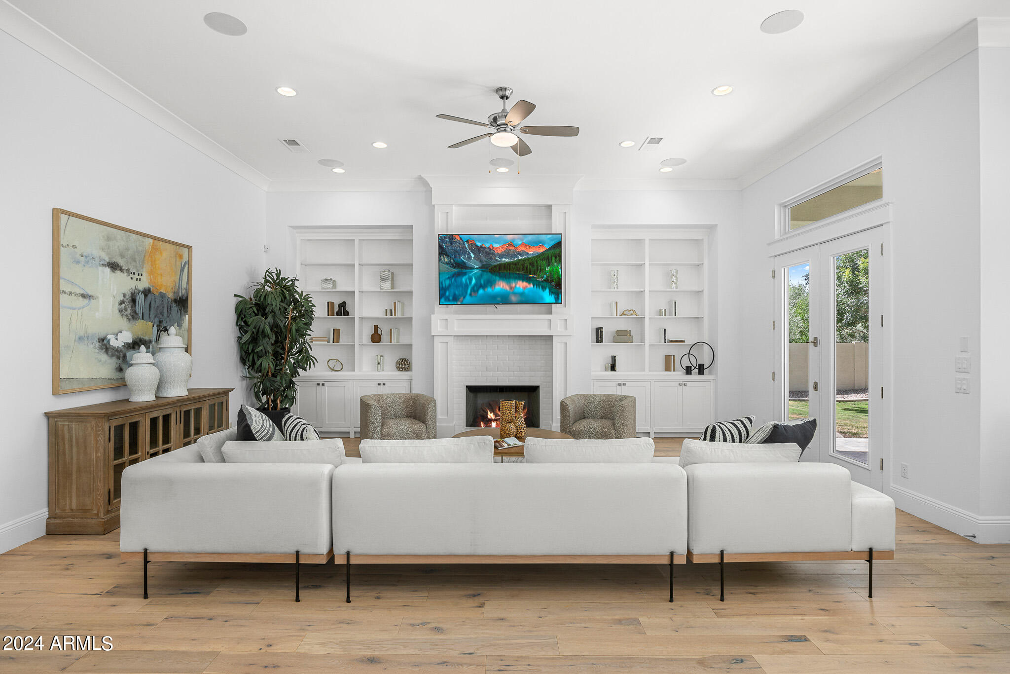 2654 East Warbler Road Gilbert, AZ 85297 - Photo 16 of 50 a living room with furniture a fireplace and a flat screen tv
