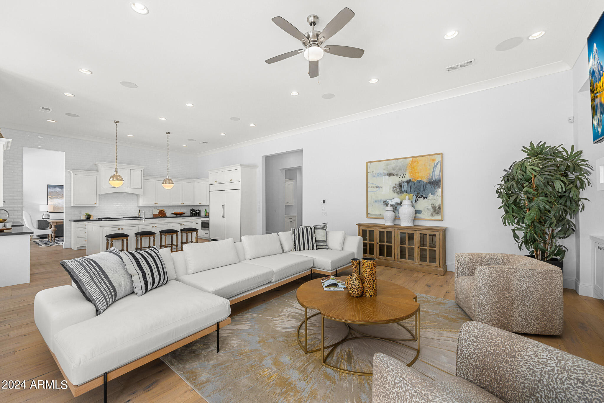 2654 East Warbler Road Gilbert, AZ 85297 - Photo 17 of 50 a living room with furniture kitchen view and a potted plant