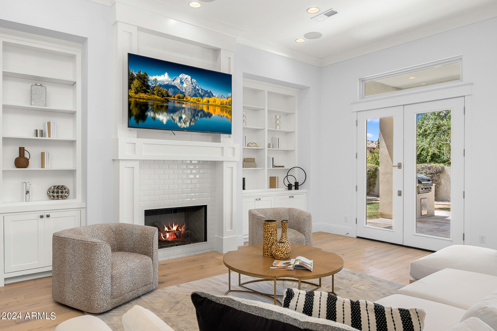 2654 East Warbler Road Gilbert, AZ 85297 - Photo 18 of 50 a living room with furniture a flat screen tv and a fireplace