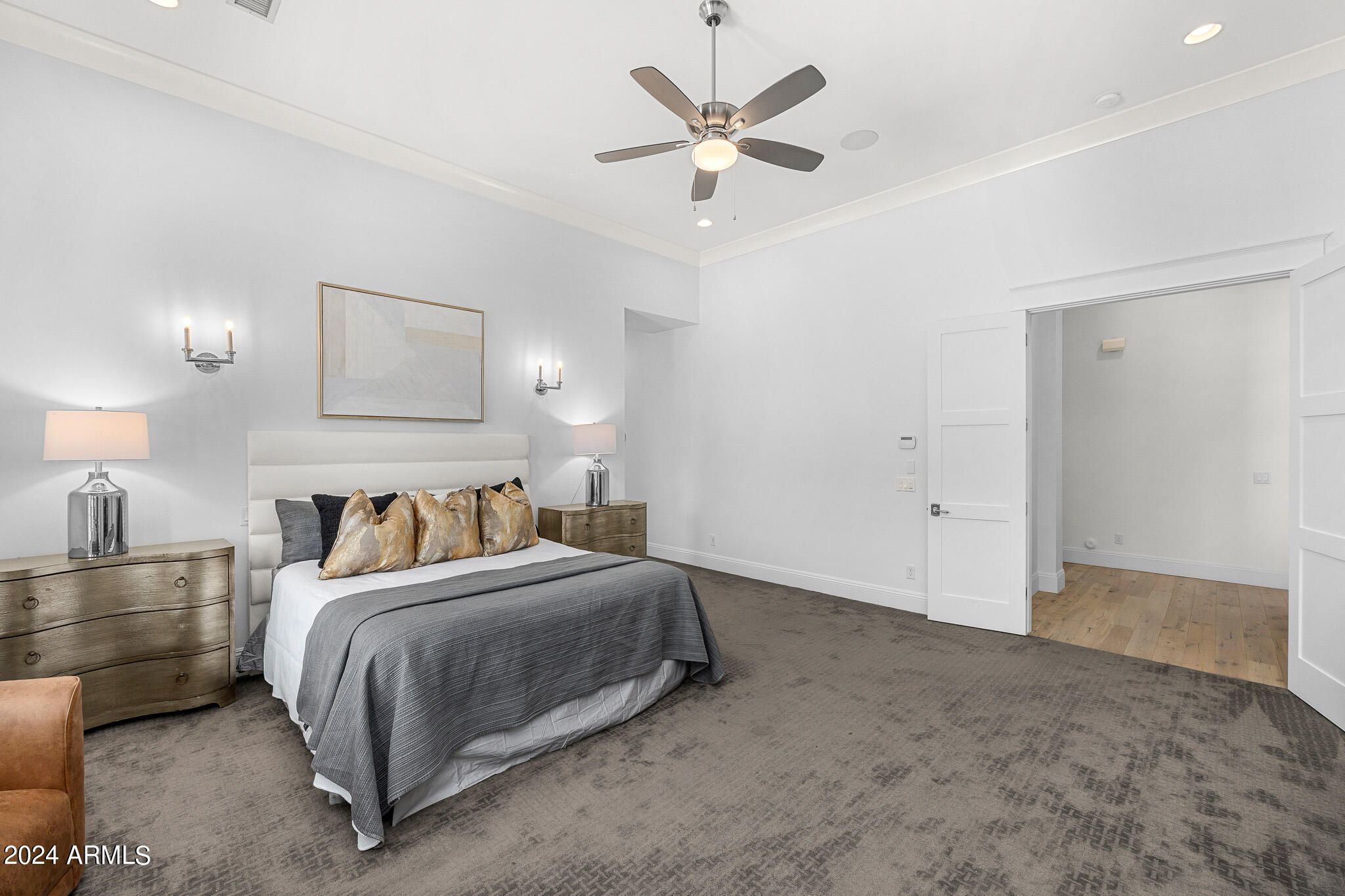 2654 East Warbler Road Gilbert, AZ 85297 - Photo 23 of 50 a bedroom with a bed and a chandelier