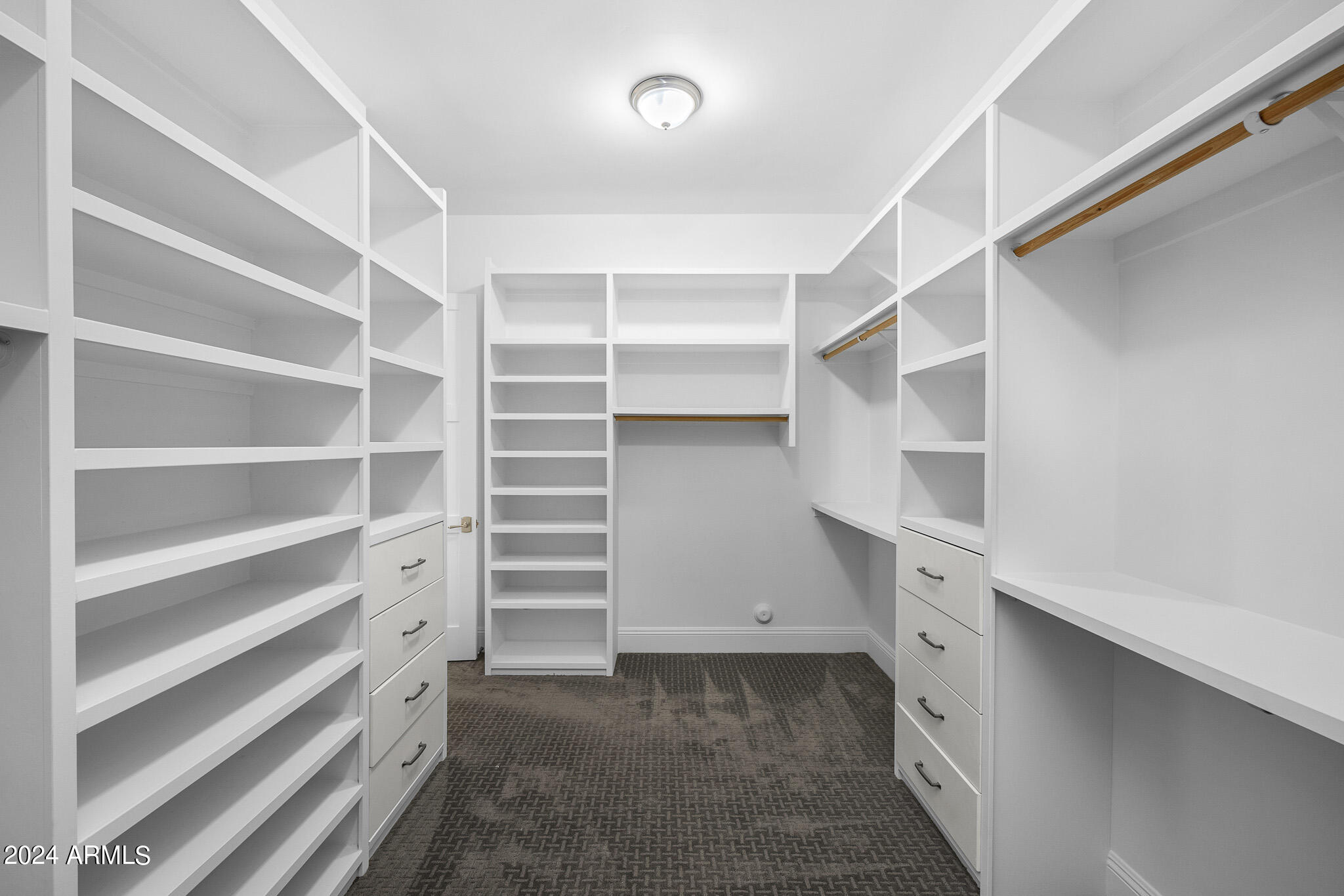 2654 East Warbler Road Gilbert, AZ 85297 - Photo 28 of 50 a view of walk in closet with empty racks