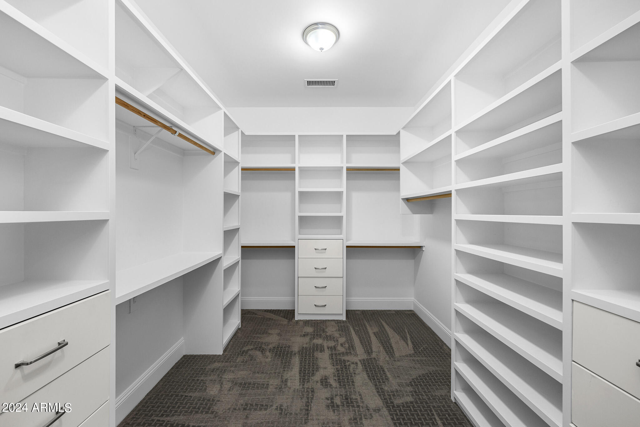 2654 East Warbler Road Gilbert, AZ 85297 - Photo 29 of 50 a view of walk in closet with empty racks