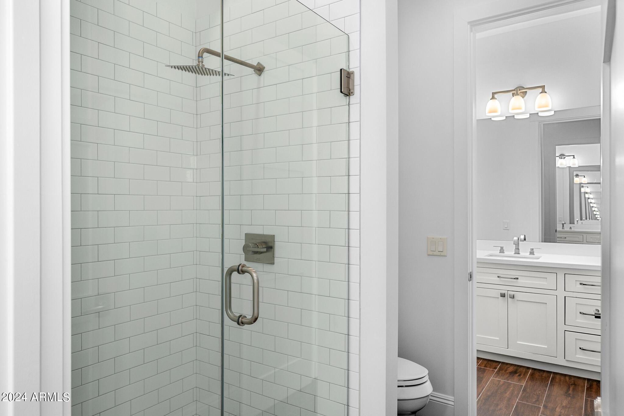 2654 East Warbler Road Gilbert, AZ 85297 - Photo 36 of 50 a bathroom with a toilet a sink a shower and mirror