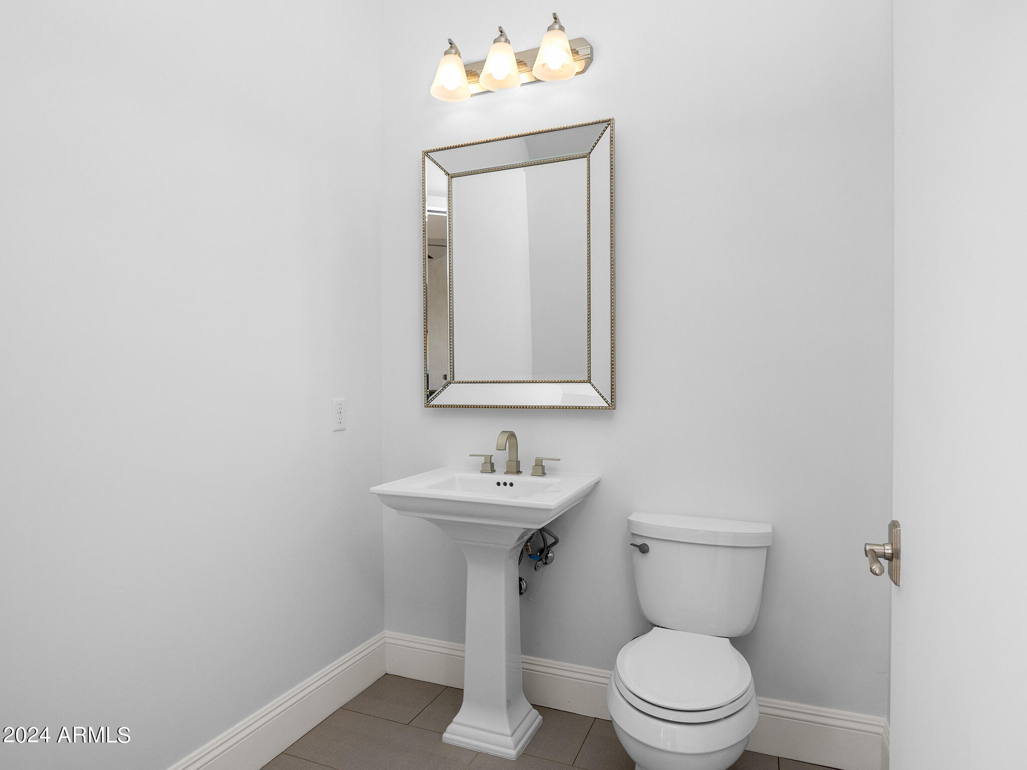 2654 East Warbler Road Gilbert, AZ 85297 - Photo 45 of 50 a bathroom with a sink mirror and toilet
