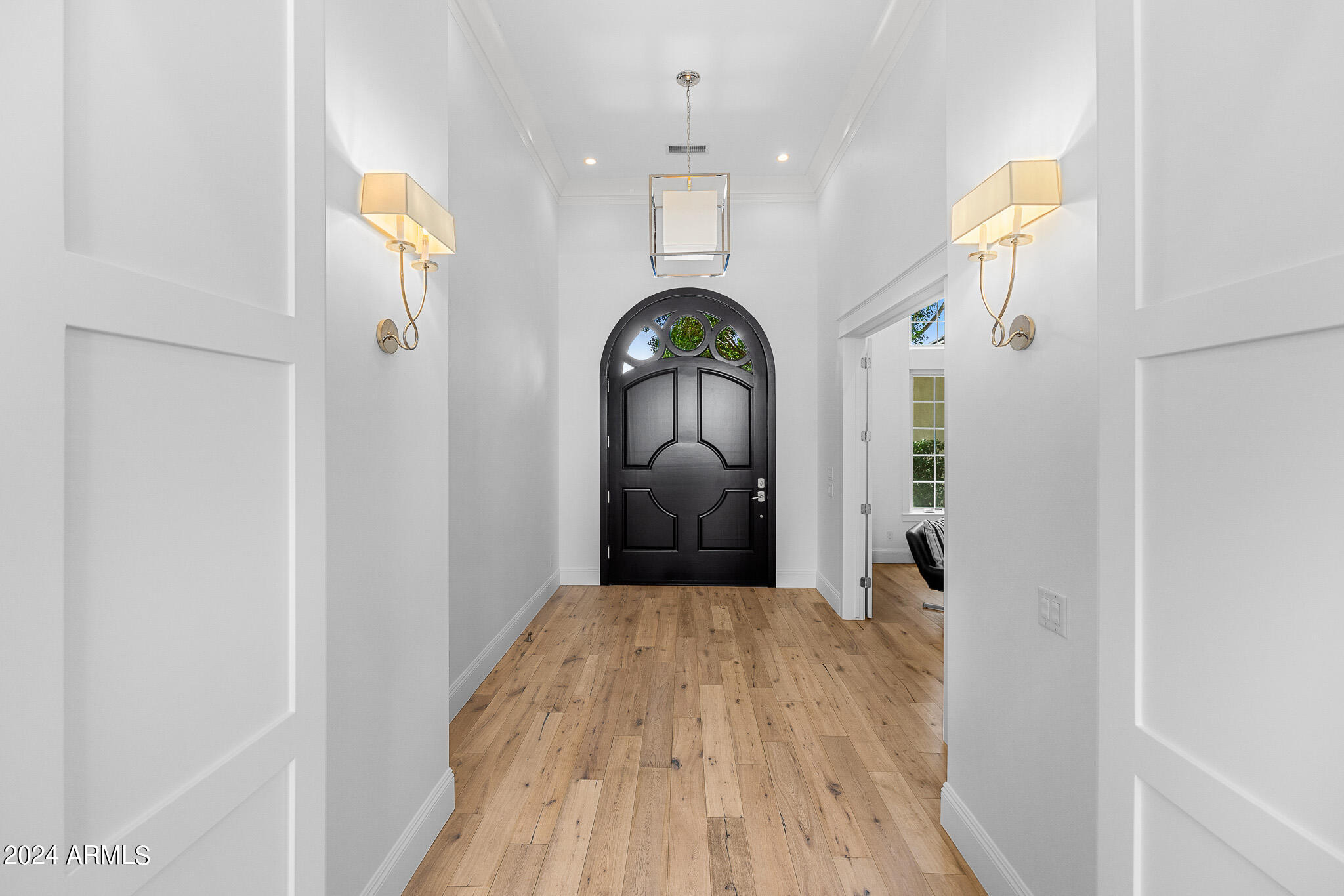 2654 East Warbler Road Gilbert, AZ 85297 - Photo 5 of 50 a view of a hallway with wooden floor and entryway