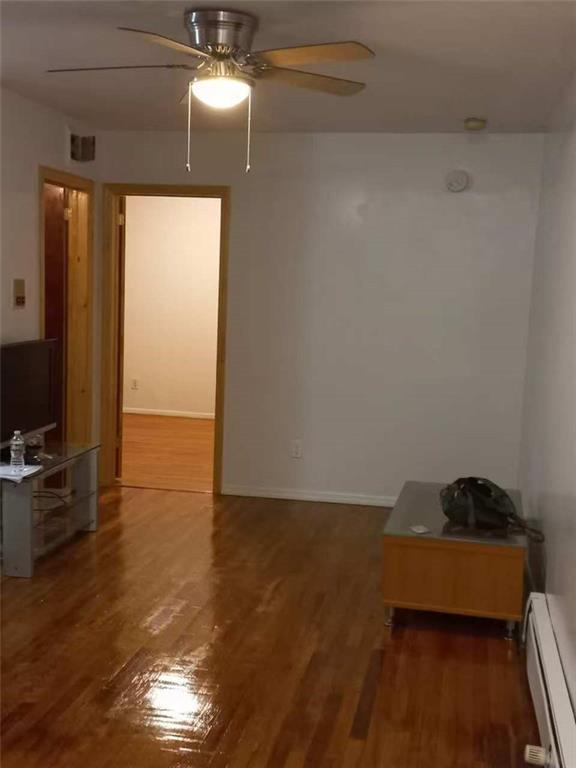 153 Bay 26th Street, Unit 1A Brooklyn, NY 11214 - Photo 2 of 6 wooden floor in an empty room with a window