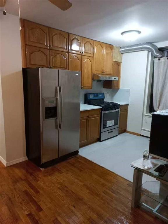153 Bay 26th Street, Unit 1A Brooklyn, NY 11214 - Photo 3 of 6 a kitchen with stainless steel appliances granite countertop a refrigerator and a stove