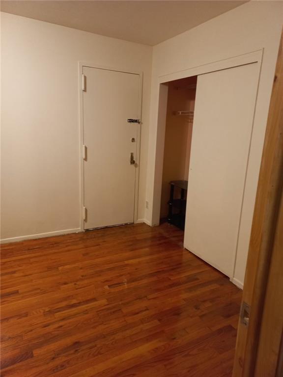 153 Bay 26th Street, Unit 1A Brooklyn, NY 11214 - Photo 4 of 6 a view of an empty room with wooden floor