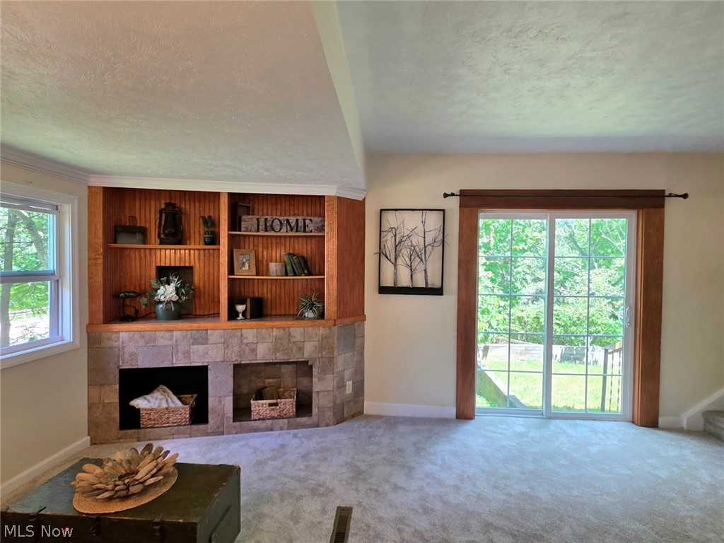 398 North Chillicothe Road Aurora, OH 44202 - Photo 11 of 39 Built-in shelving with wood paneling and stone-look surround, featuring two lower recesses