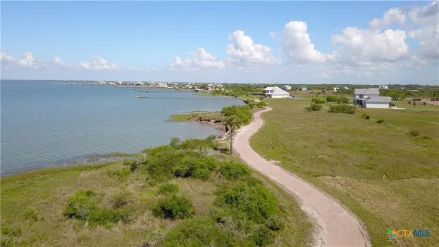 a view of a lake with houses in the back