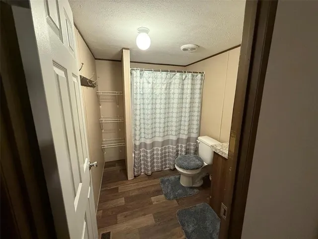 a bathroom with a toilet and shower