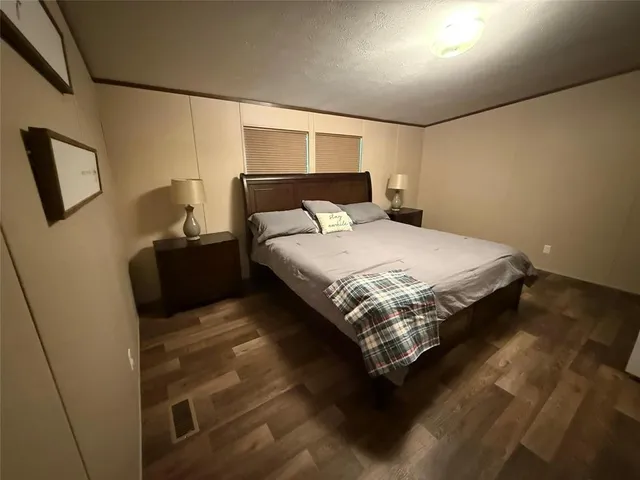 a large bed sitting in a bedroom next to a lamp