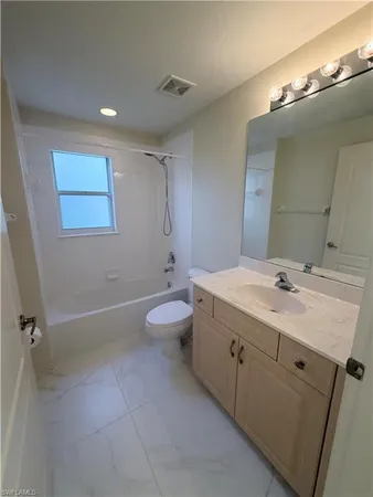 a bathroom with a double vanity sink toilet and a mirror