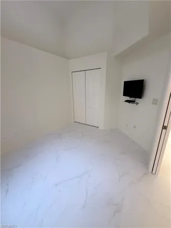 a view of a livingroom with an empty space and a flat screen tv