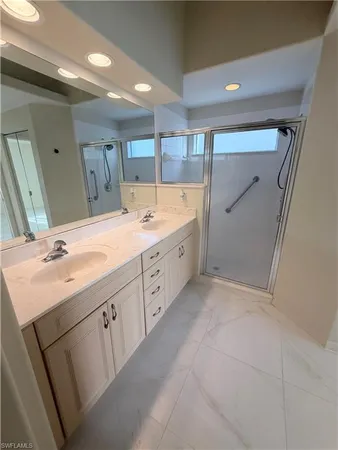 a spacious bathroom with a double vanity sink and mirror