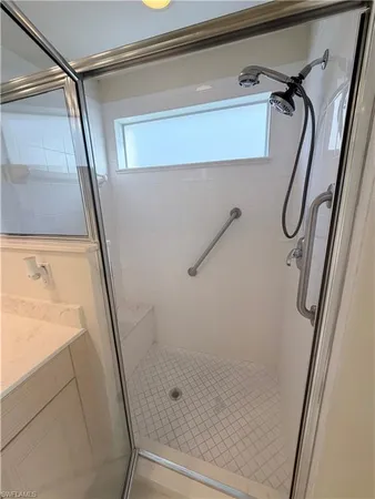 a white toilet sitting next to a white wall