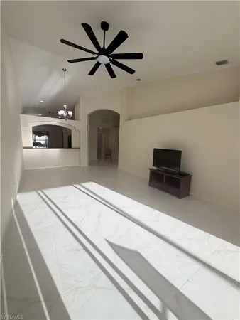 a living room with furniture and a ceiling fan