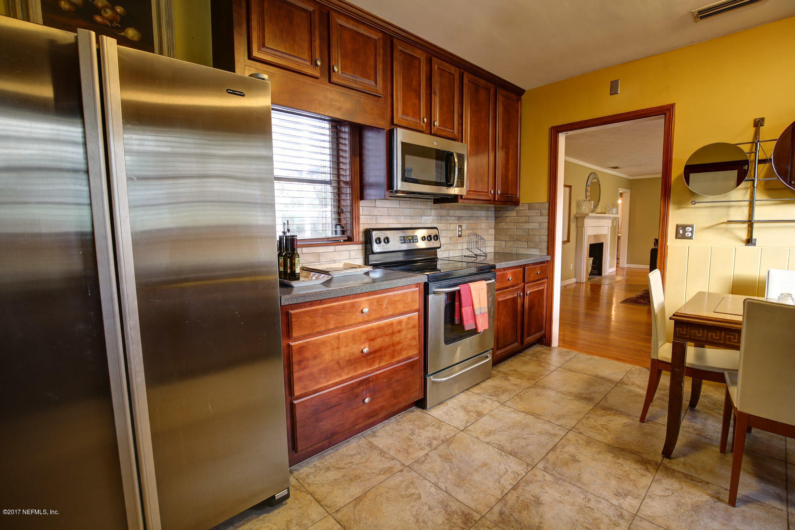 1361 Glengarry Road Jacksonville, FL 32207 - Photo 11 of 22 a kitchen with stainless steel appliances granite countertop a refrigerator a stove and a sink with granite countertops