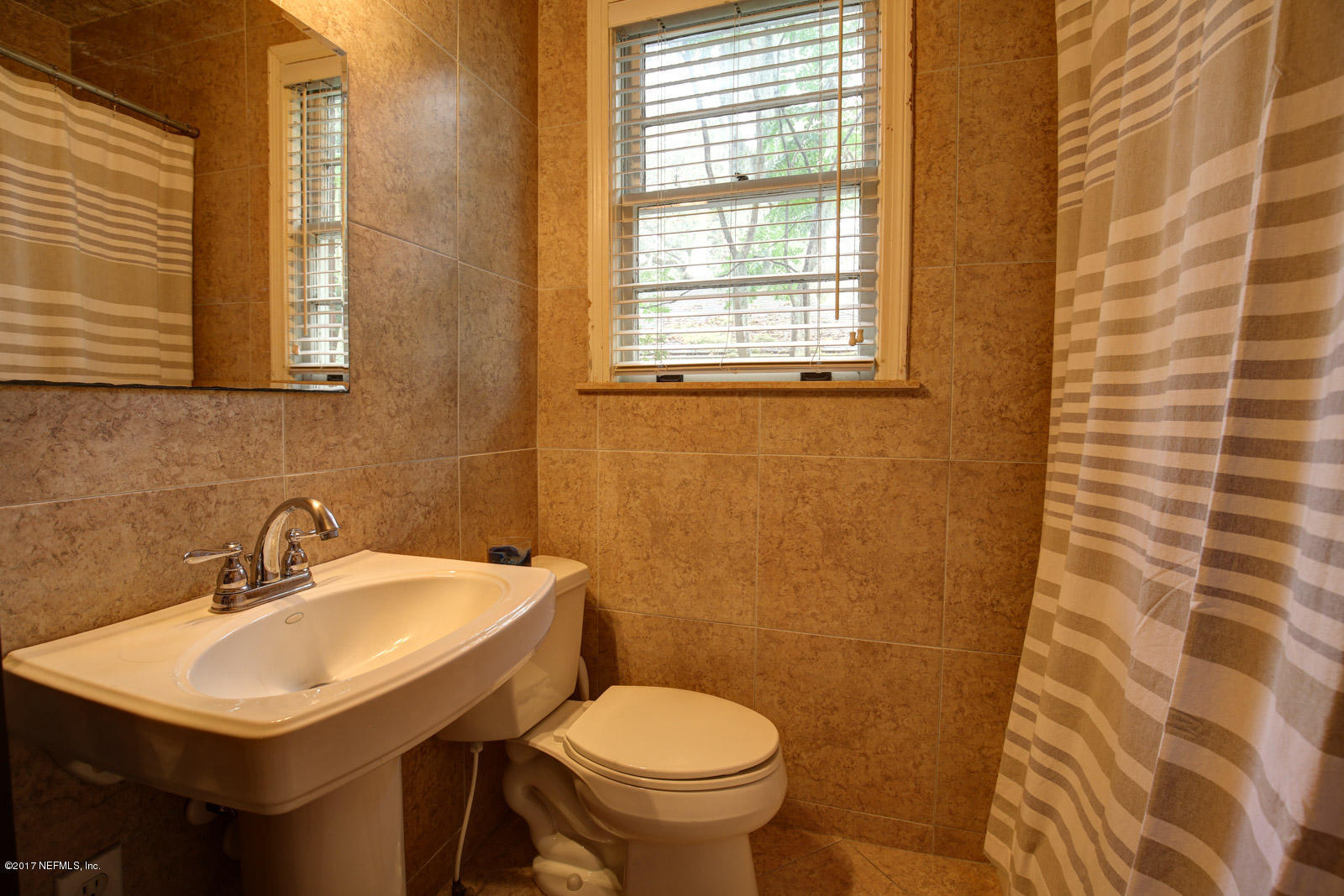 1361 Glengarry Road Jacksonville, FL 32207 - Photo 19 of 22 a bathroom with a sink and a toilet