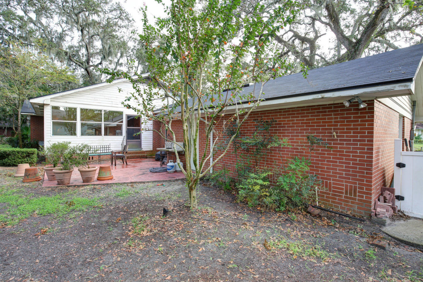 1361 Glengarry Road Jacksonville, FL 32207 - Photo 22 of 22 a backyard of a house with plants and outdoor seating