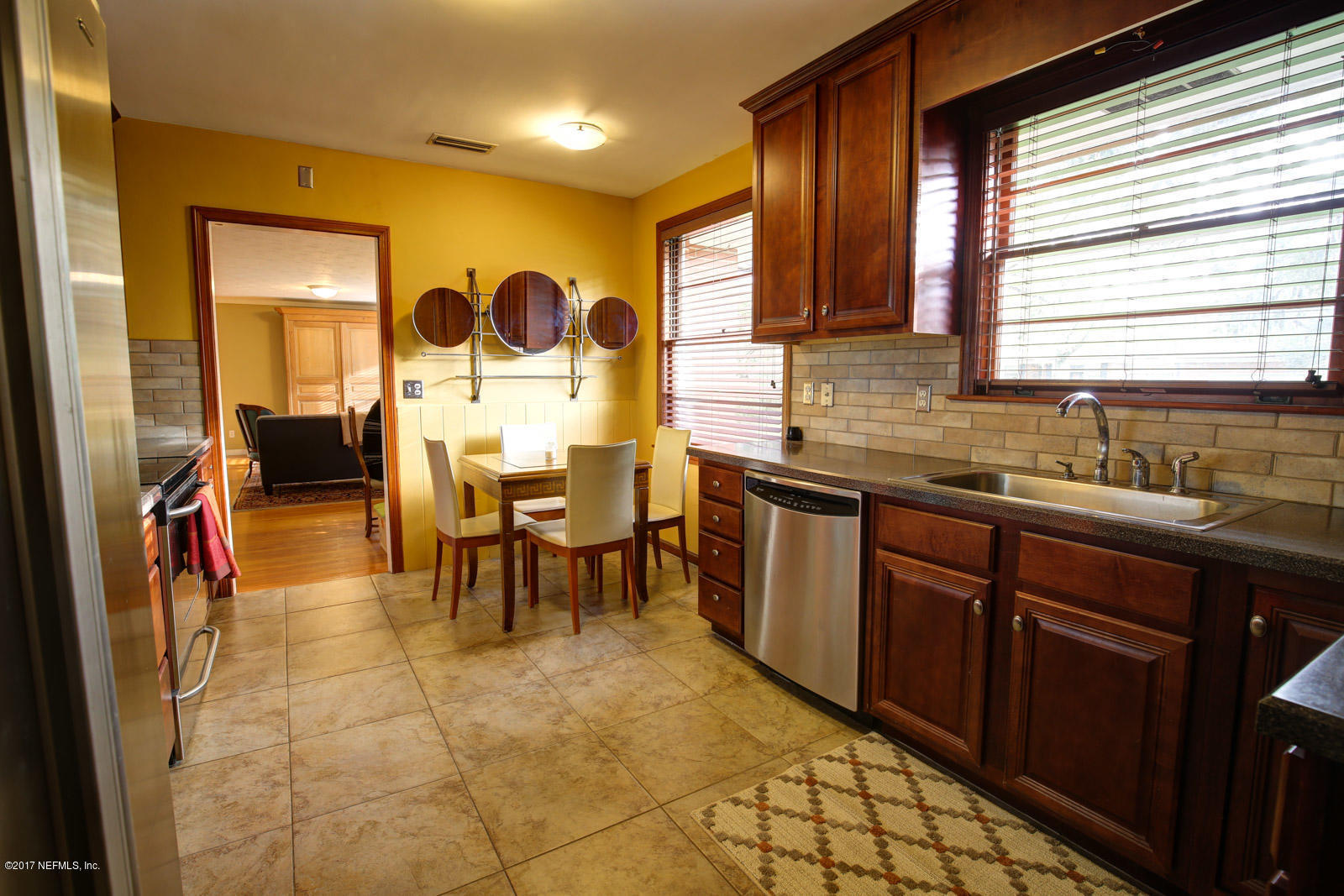 1361 Glengarry Road Jacksonville, FL 32207 - Photo 10 of 22 a kitchen with stainless steel appliances granite countertop sink table and chairs
