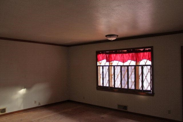 301 Watts Avenue Ralls, TX 79357 - Photo 7 of 10 a view of wooden floor and windows in a room