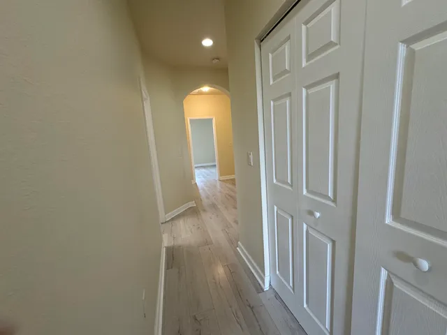 an empty room with wooden floor and closet