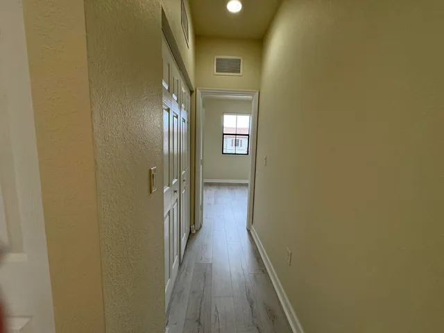 a view of hallway with wooden floor