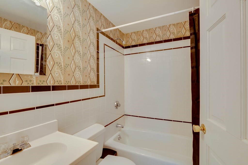 64 Grosvenor Road Needham, MA 02492 - Photo 12 of 36 a bathroom with a bathtub and a sink