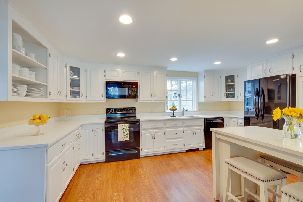 64 Grosvenor Road Needham, MA 02492 - Photo 14 of 36 a large kitchen with stainless steel appliances granite countertop a stove and a sink