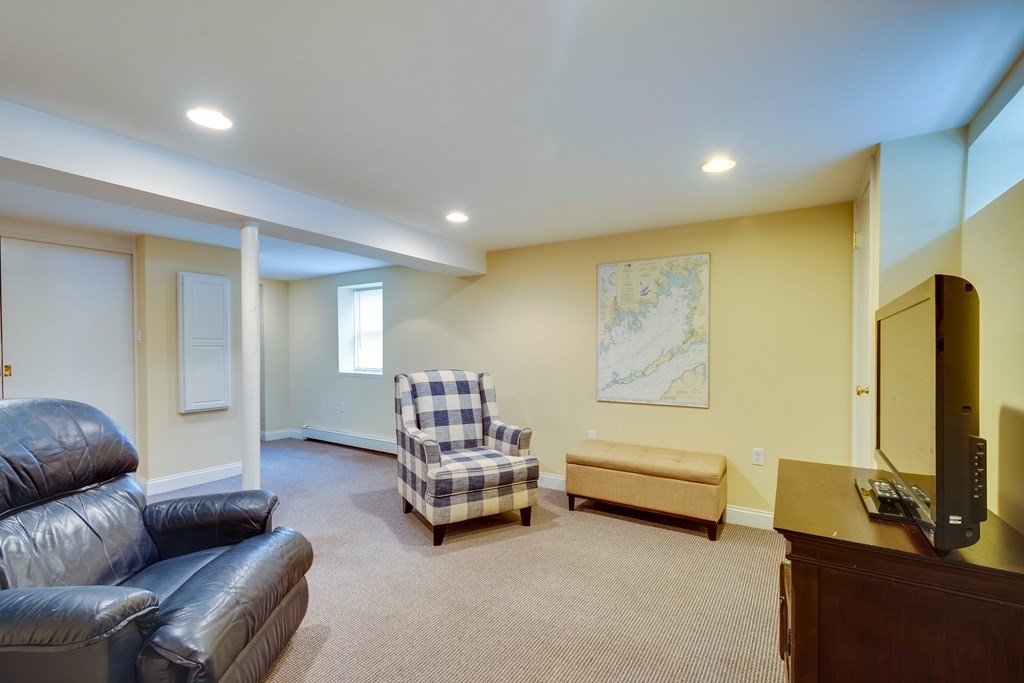 64 Grosvenor Road Needham, MA 02492 - Photo 29 of 36 a living room with furniture and a flat screen tv