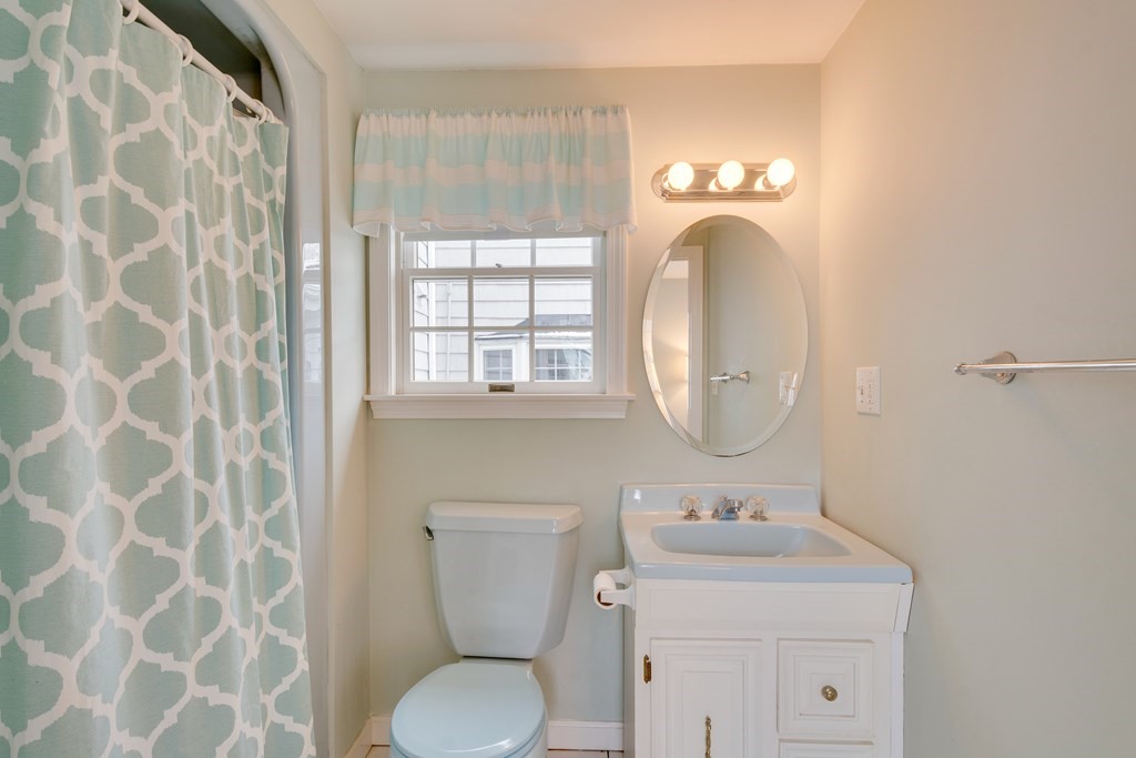 64 Grosvenor Road Needham, MA 02492 - Photo 10 of 36 a bathroom with a toilet sink and mirror