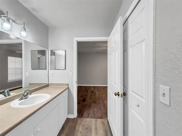 a spacious bathroom with a double vanity sink and mirror